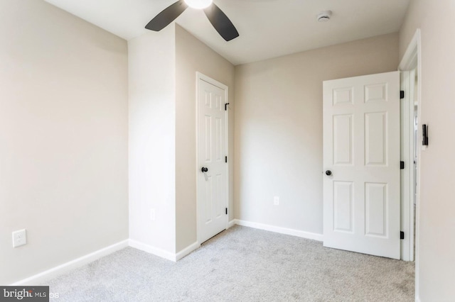 unfurnished bedroom with light carpet and ceiling fan