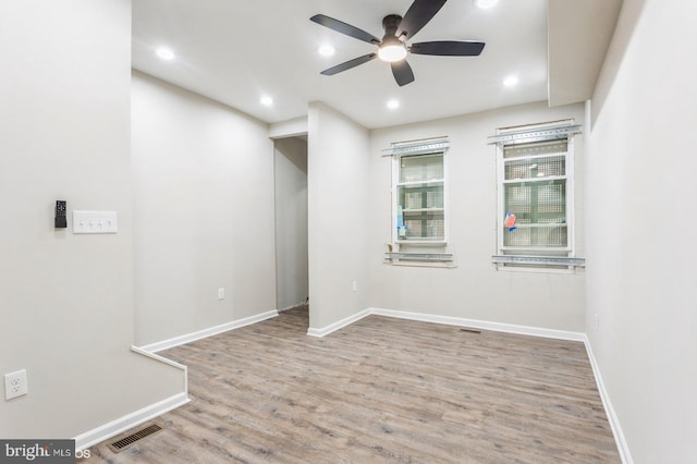 empty room with ceiling fan and light wood-type flooring