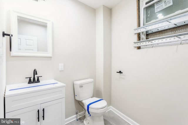 bathroom with tile patterned floors, vanity, and toilet