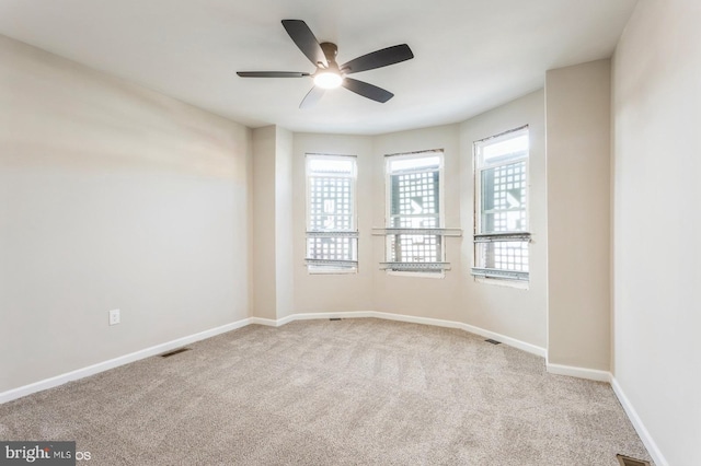 carpeted empty room featuring ceiling fan