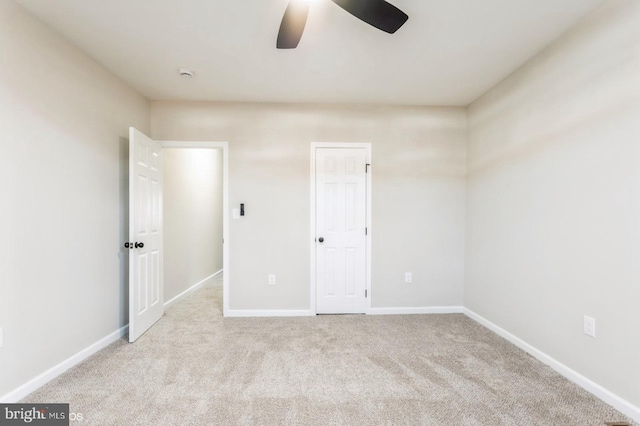 unfurnished bedroom featuring ceiling fan and light colored carpet