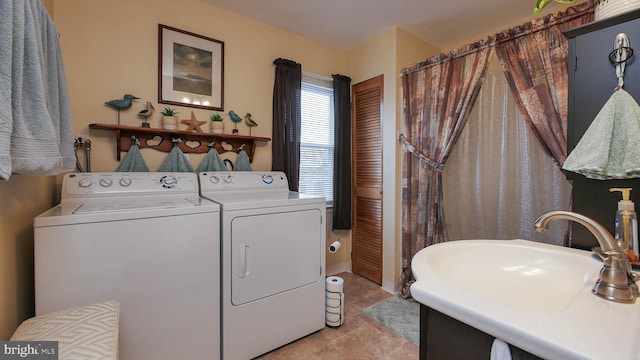 clothes washing area with independent washer and dryer, sink, and light tile patterned floors