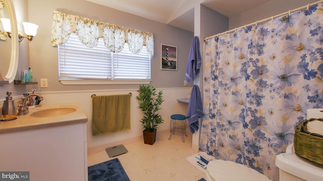 bathroom featuring a shower with shower curtain, vanity, toilet, and tile patterned floors