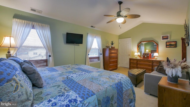 bedroom with light colored carpet, ceiling fan, and lofted ceiling