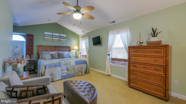 carpeted bedroom featuring ceiling fan, lofted ceiling, and multiple windows