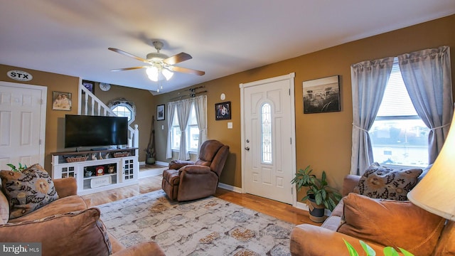 living room featuring ceiling fan and light hardwood / wood-style flooring