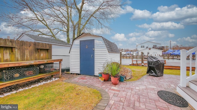 view of outbuilding featuring a yard and a water view