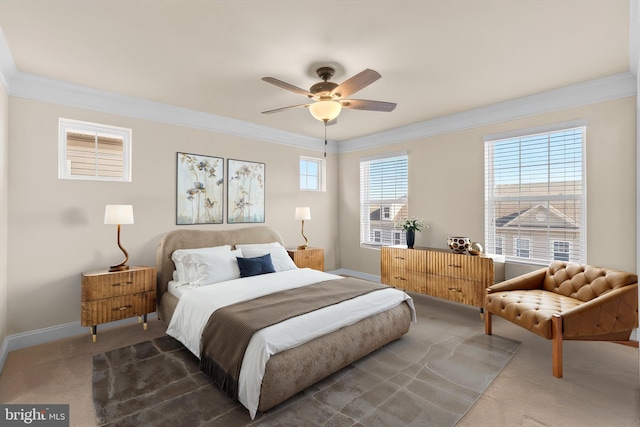 carpeted bedroom featuring ceiling fan and crown molding