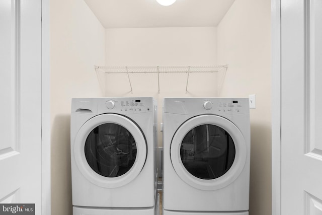 clothes washing area with washer and dryer