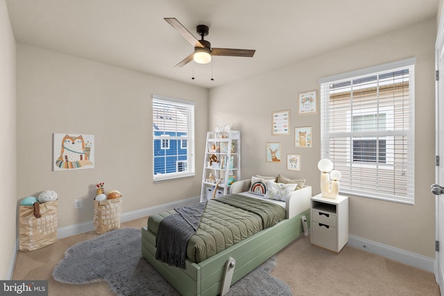 bedroom with light colored carpet and ceiling fan