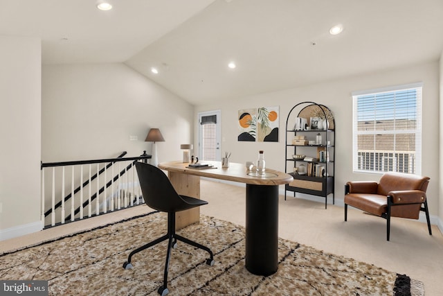 home office with light carpet and vaulted ceiling