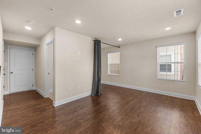 empty room with dark wood-type flooring