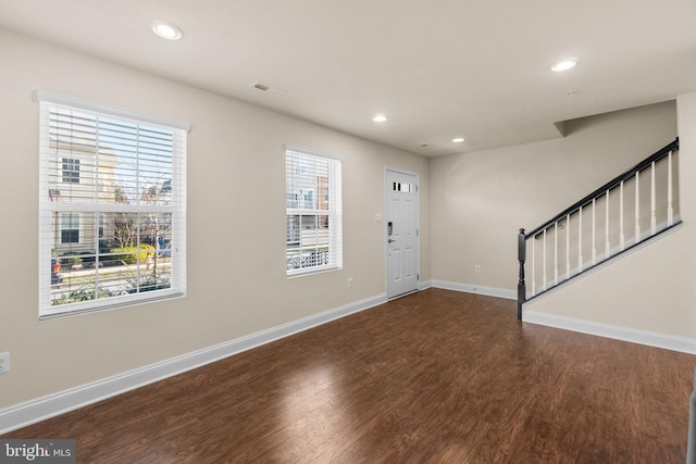 entrance foyer with a healthy amount of sunlight and dark wood-type flooring