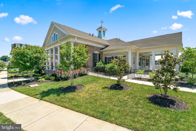 view of front of property featuring covered porch and a front lawn