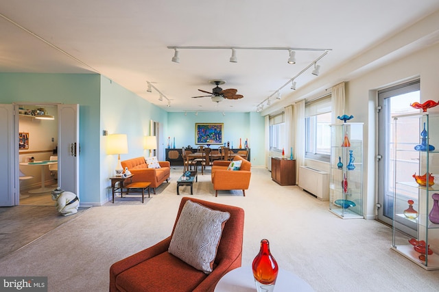 living room with carpet, rail lighting, and ceiling fan