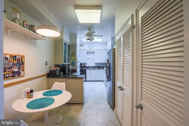 kitchen featuring kitchen peninsula, stainless steel fridge, and ceiling fan