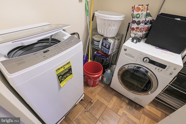 laundry area with parquet flooring and washer and dryer