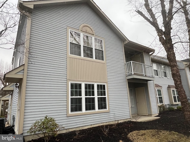 back of house featuring a balcony