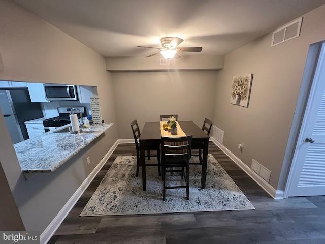 dining room featuring dark hardwood / wood-style flooring and ceiling fan