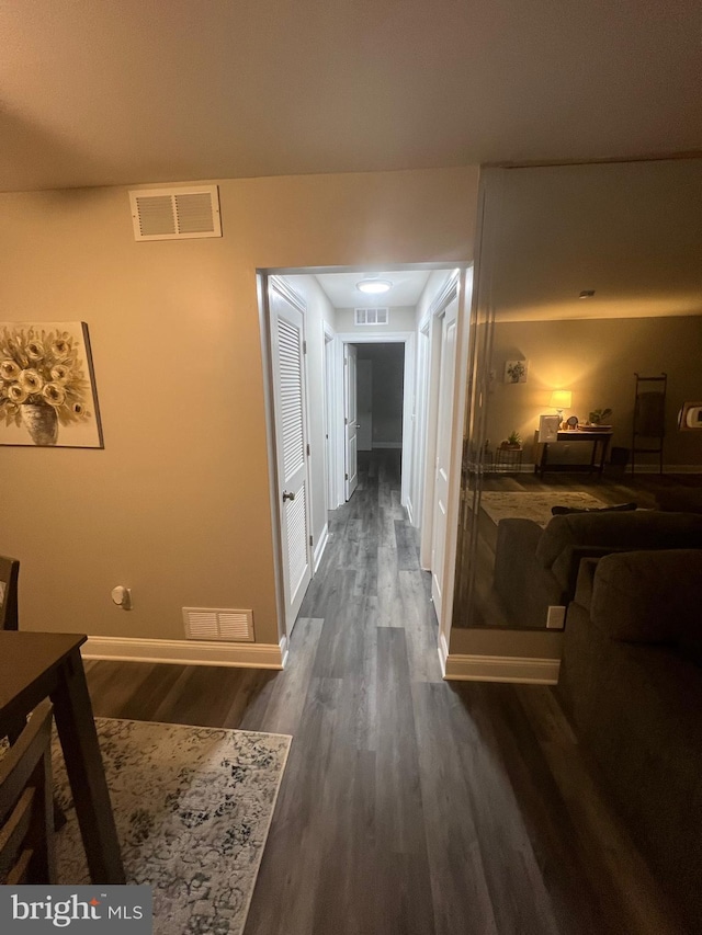 hall with dark wood-type flooring