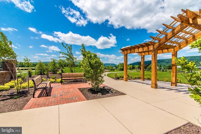 view of patio / terrace with a mountain view and a pergola