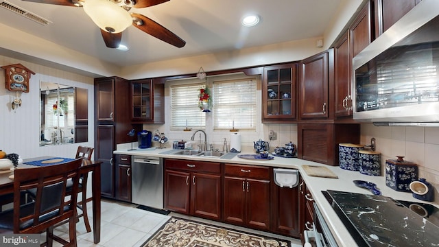 kitchen featuring backsplash, sink, ceiling fan, light tile patterned floors, and appliances with stainless steel finishes