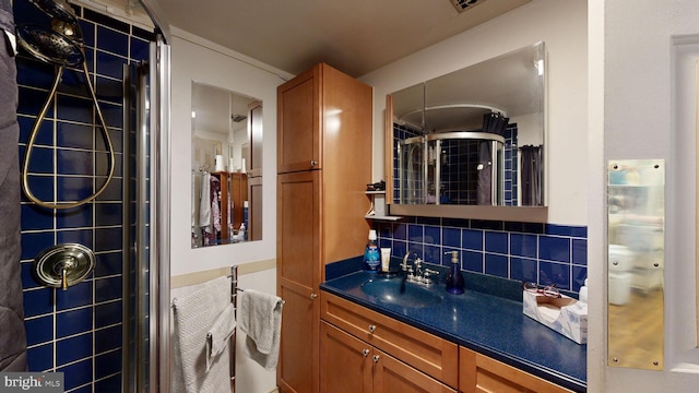 bathroom featuring tasteful backsplash, vanity, and tiled shower