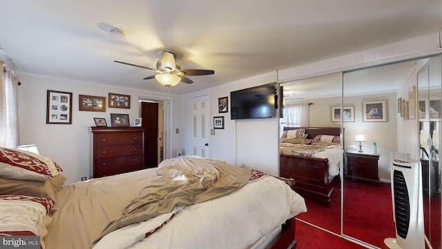 bedroom with carpet, a closet, ceiling fan, ornamental molding, and heating unit