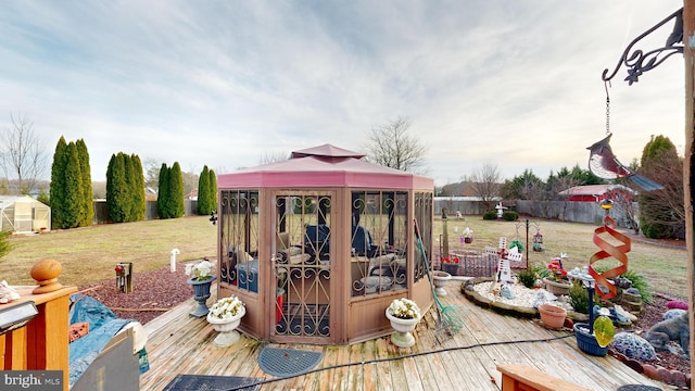 wooden deck with a gazebo and a lawn