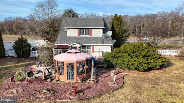 view of front of house with a gazebo and a front lawn