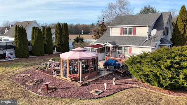 back of property featuring a gazebo