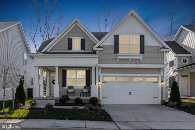 view of front of home with covered porch and a garage