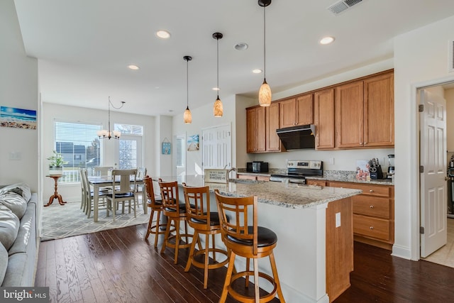 kitchen with dark wood-type flooring, a kitchen island with sink, hanging light fixtures, electric range, and a notable chandelier