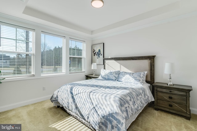 bedroom with light carpet and multiple windows