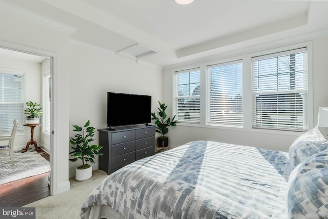 bedroom featuring carpet floors, ornamental molding, and multiple windows