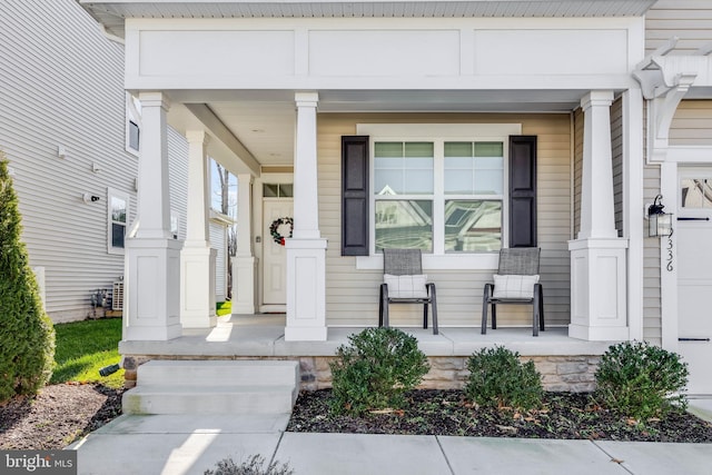 view of exterior entry featuring covered porch