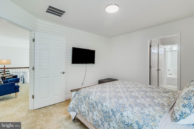 carpeted bedroom with ensuite bath