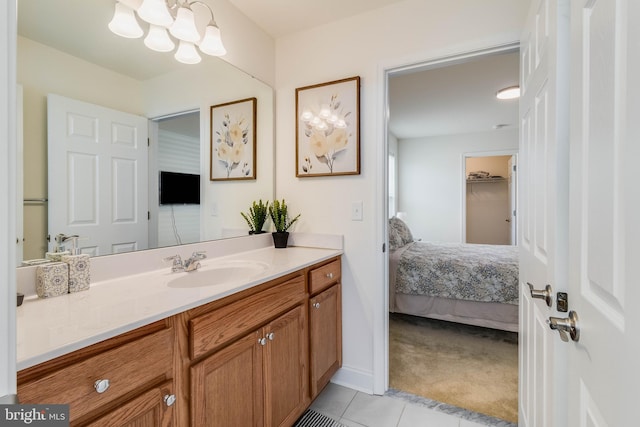 bathroom featuring a chandelier, vanity, and tile patterned floors