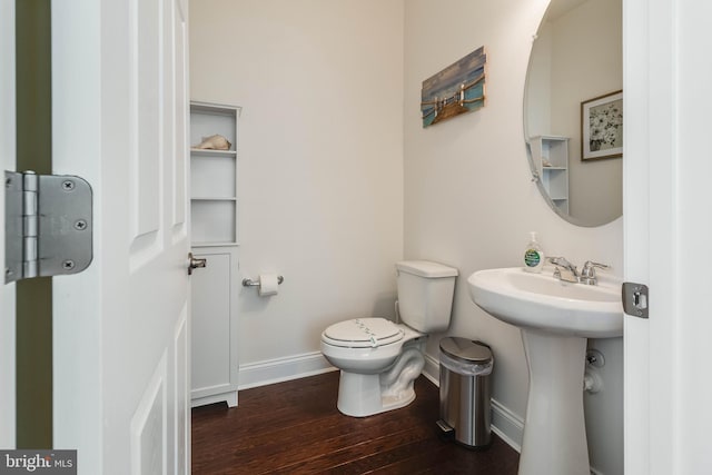 bathroom featuring hardwood / wood-style floors, toilet, and sink