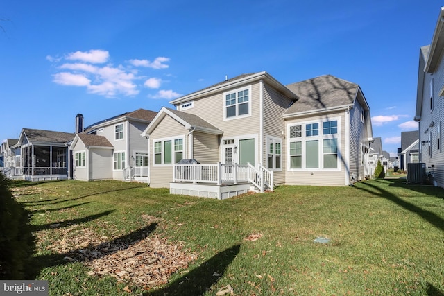 back of property featuring a yard, a deck, and central AC unit