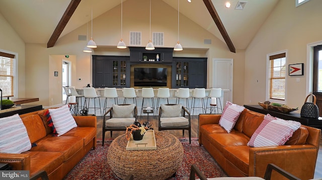 living room with high vaulted ceiling