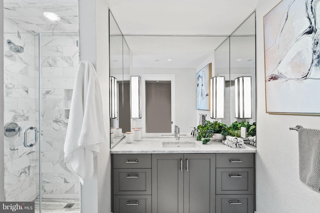 bathroom with walk in shower and vanity