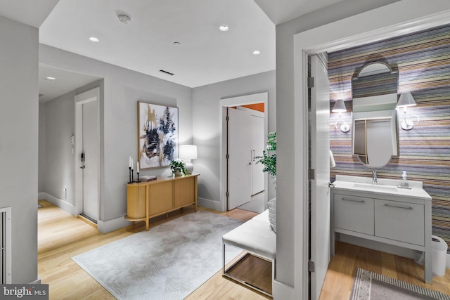 interior space with light hardwood / wood-style floors and sink