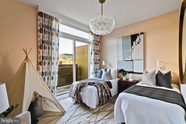 bedroom featuring access to outside and a notable chandelier