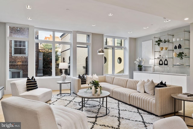 living room featuring light wood-type flooring and a fireplace