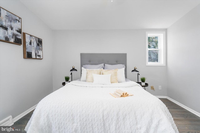 bedroom with dark hardwood / wood-style flooring