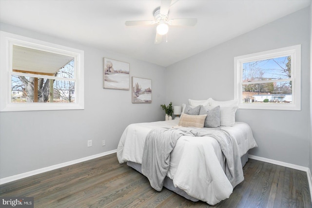 bedroom featuring multiple windows, ceiling fan, dark wood-type flooring, and lofted ceiling