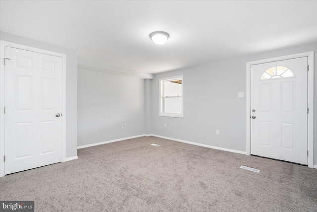 view of carpeted foyer