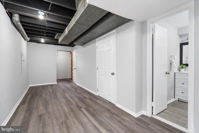 basement with hardwood / wood-style floors