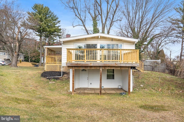 back of house with a lawn and a deck